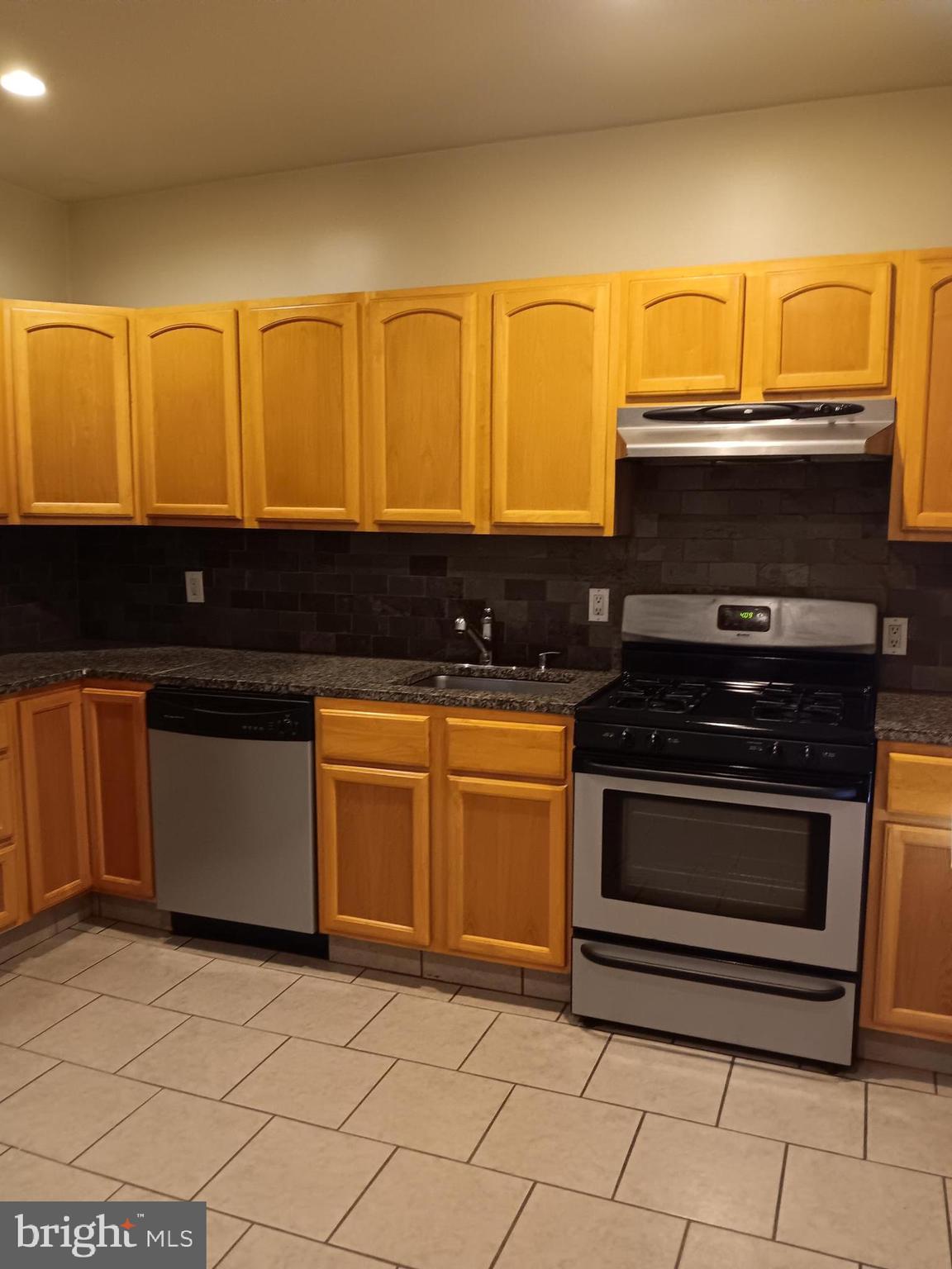 712 Central Avenue, Unit B Glendora, NJ 08029 - Photo 3 of 11 a kitchen with granite countertop a stove and a sink
