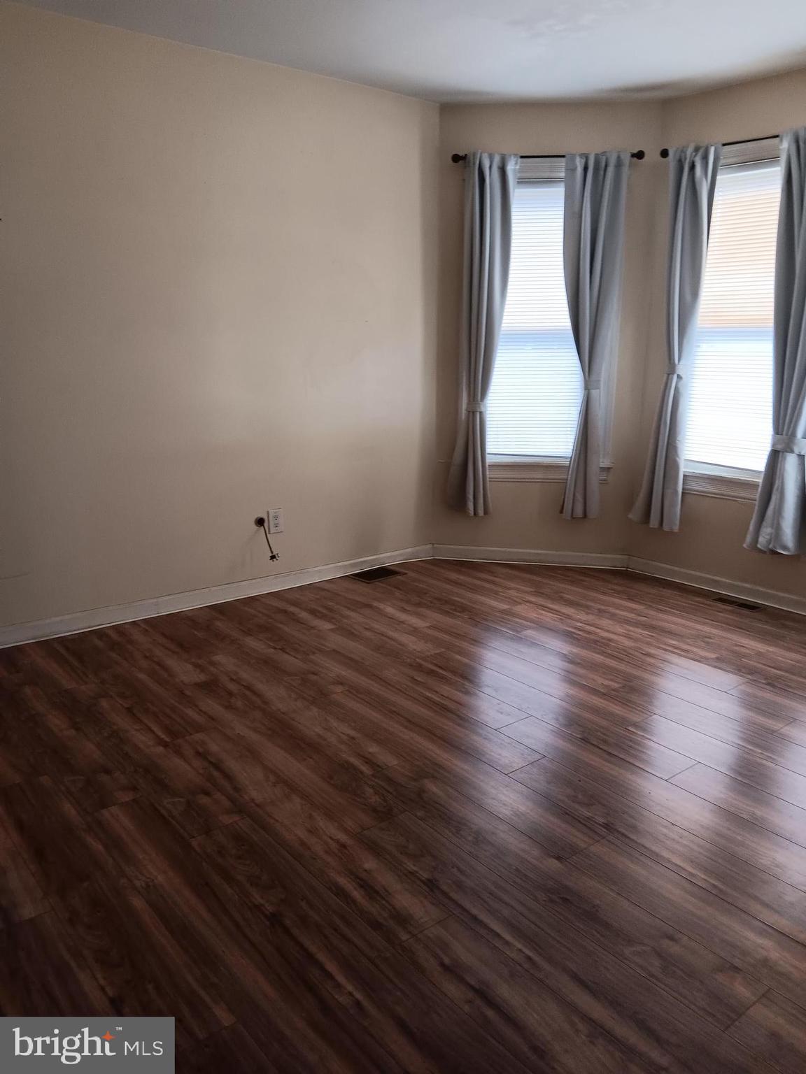 712 Central Avenue, Unit B Glendora, NJ 08029 - Photo 6 of 11 an empty room with wooden floor and windows