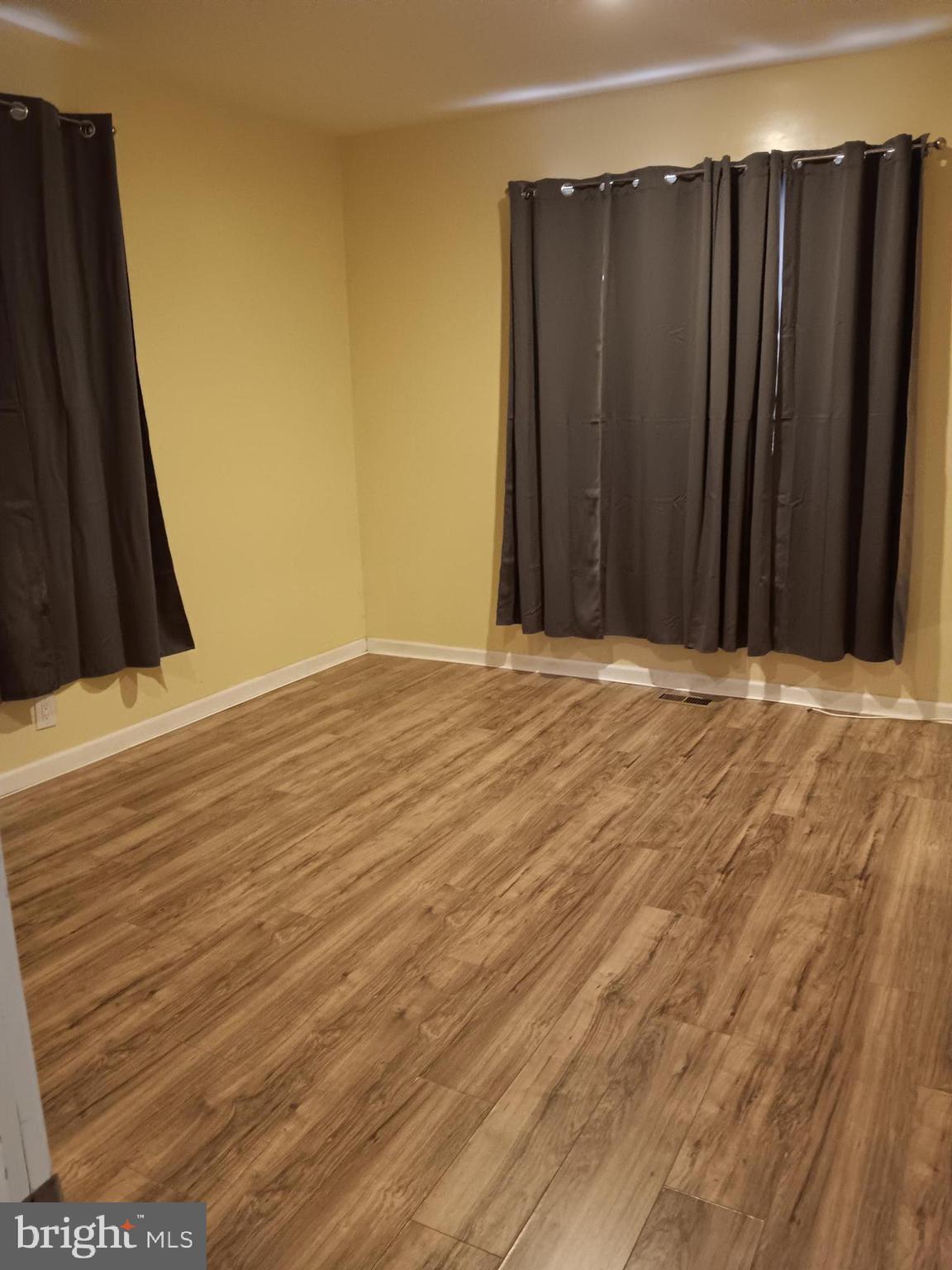 712 Central Avenue, Unit B Glendora, NJ 08029 - Photo 10 of 11 a view of an empty room with wooden floor