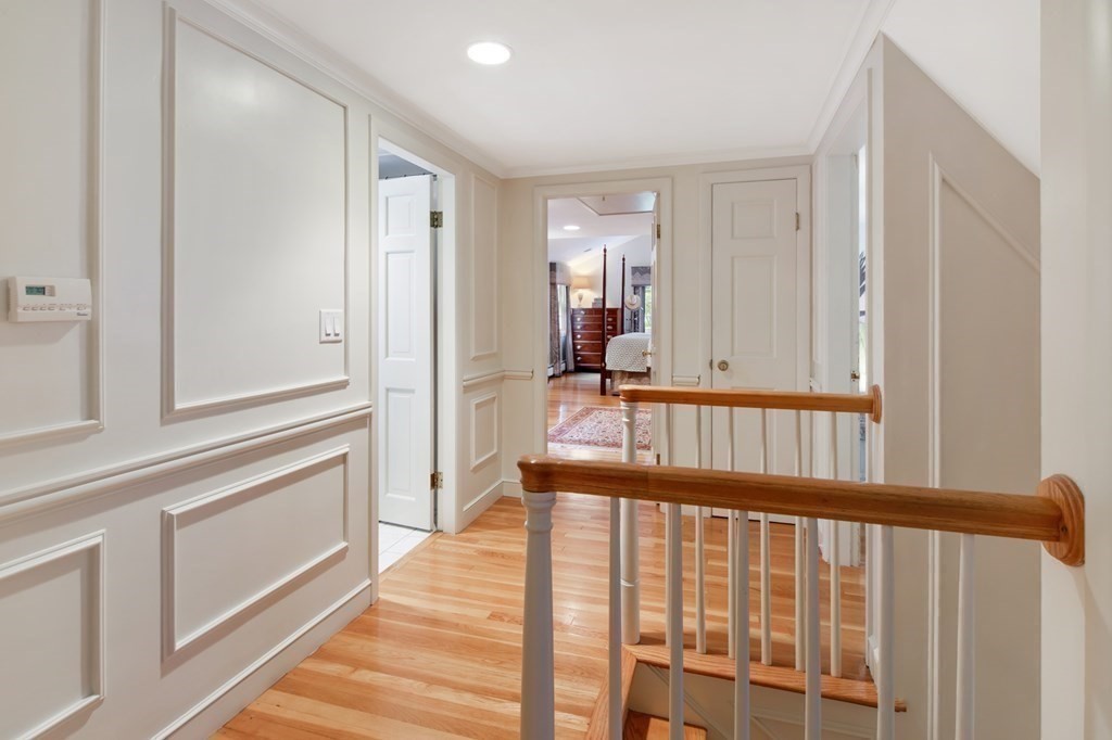 6 Bishops Lane Hingham, MA 02043 - Photo 15 of 22 a view of a hallway with wooden floor and staircase