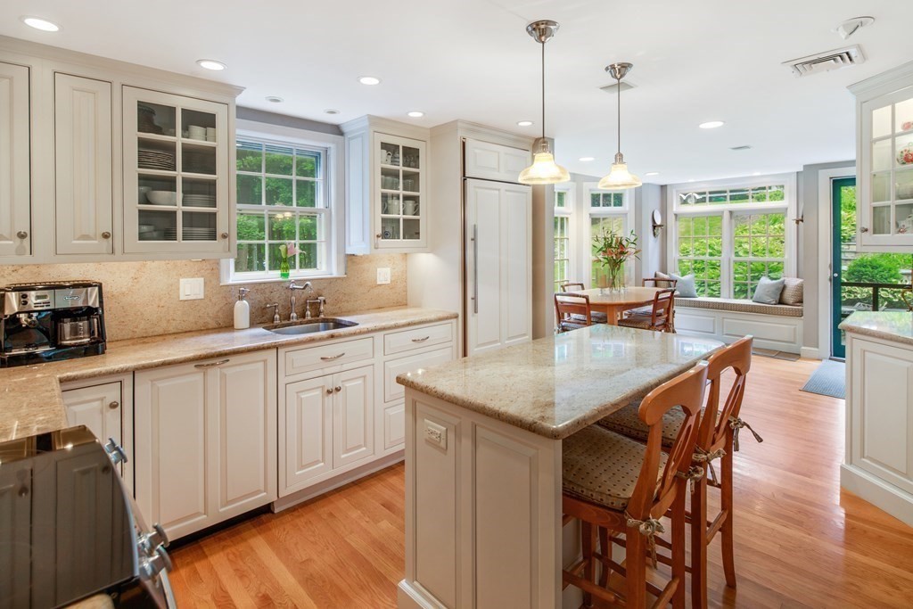 6 Bishops Lane Hingham, MA 02043 - Photo 2 of 22 a kitchen with granite countertop white cabinets and stainless steel appliances