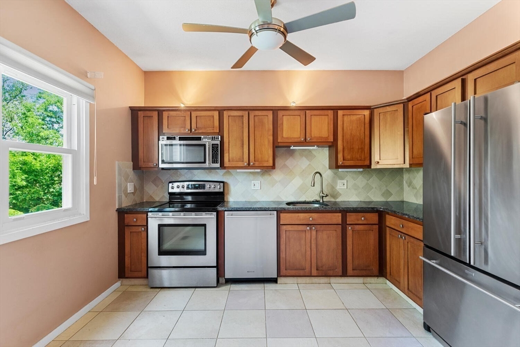 9 Fillmore Road, Unit 9C Salem, MA 01970 - Photo 12 of 22 a kitchen with stainless steel appliances granite countertop a refrigerator and a sink