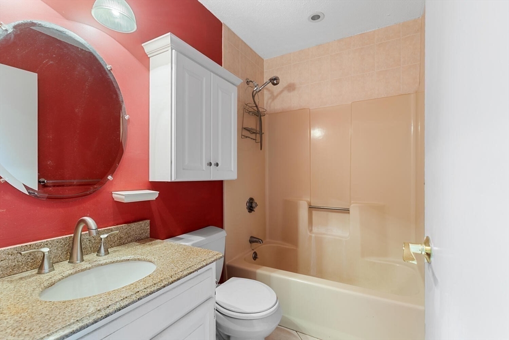 9 Fillmore Road, Unit 9C Salem, MA 01970 - Photo 16 of 22 a bathroom with a granite countertop sink toilet and shower