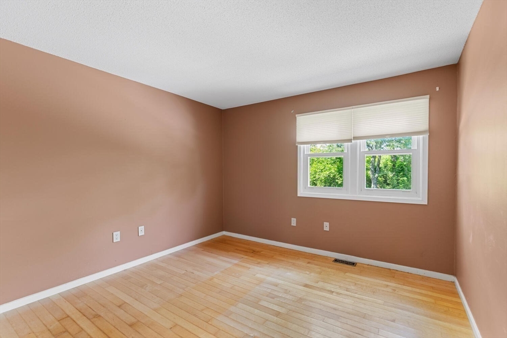 9 Fillmore Road, Unit 9C Salem, MA 01970 - Photo 17 of 22 an empty room with wooden floor and windows