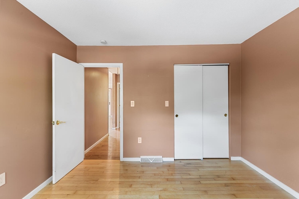 9 Fillmore Road, Unit 9C Salem, MA 01970 - Photo 18 of 22 a view of an empty room with wooden floor