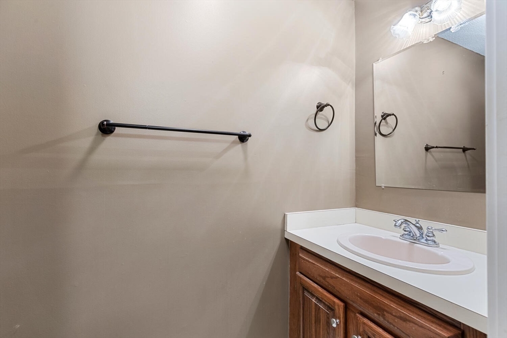 9 Fillmore Road, Unit 9C Salem, MA 01970 - Photo 21 of 22 a bathroom with a sink and a mirror