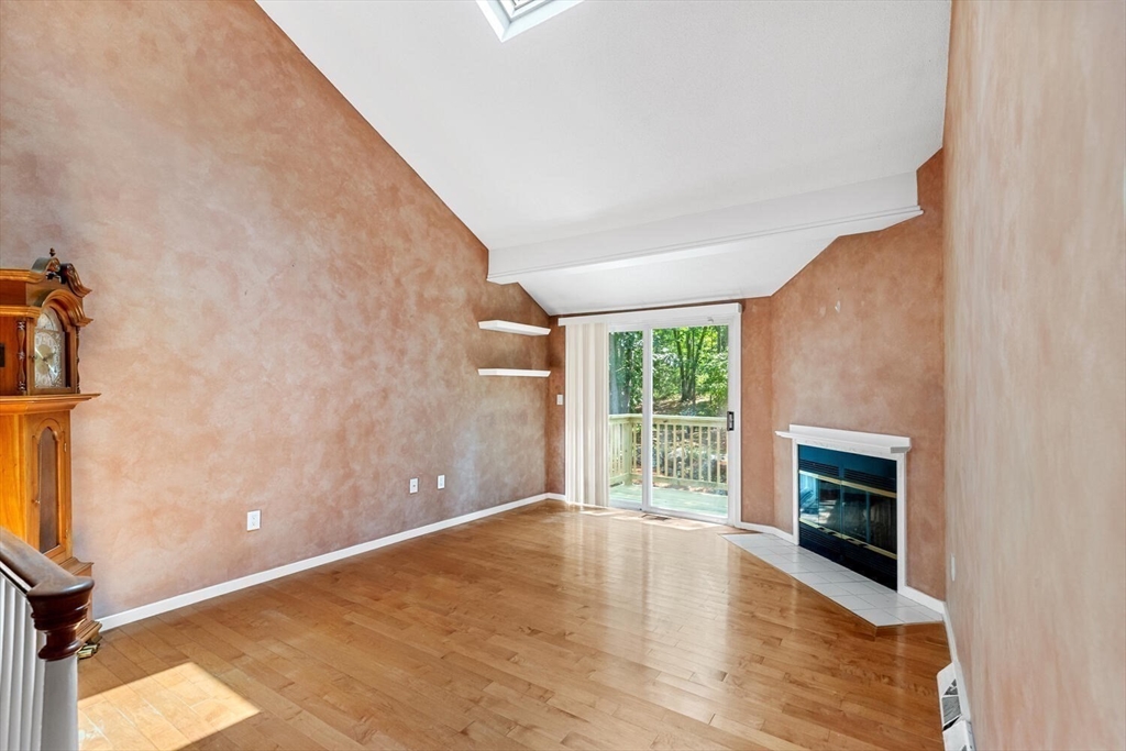 9 Fillmore Road, Unit 9C Salem, MA 01970 - Photo 4 of 22 a view of empty room with wooden floor and fireplace