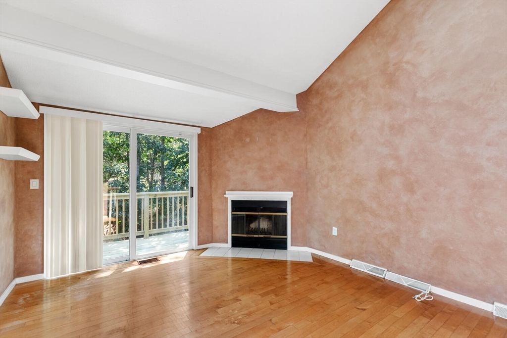9 Fillmore Road, Unit 9C Salem, MA 01970 - Photo 5 of 22 a view of an empty room with a fireplace and a window