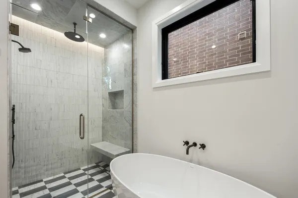 a bathroom with double vanity sinks a shower a mirror and a shower