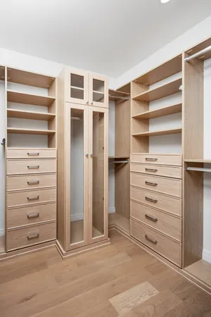 a view of walk in closet with empty racks