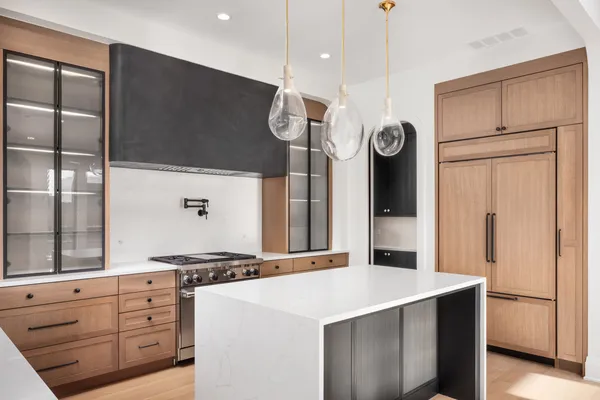 a kitchen with stainless steel appliances a stove a sink and a refrigerator