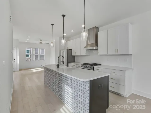 a large kitchen with stainless steel appliances granite countertop a sink a stove and a granite counter tops