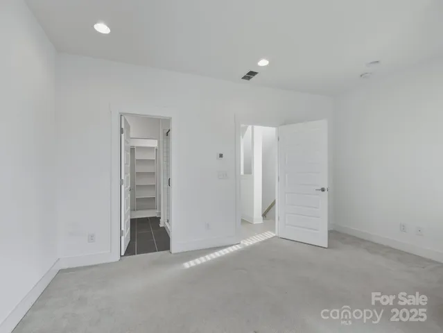 an empty room with closet and natural light