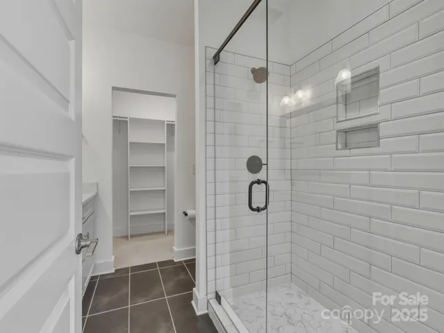 a bathroom with a glass door shower