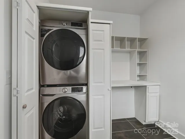 a utility room with cabinets dryer and washer