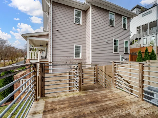 a view of a house with wooden fence and a stairs