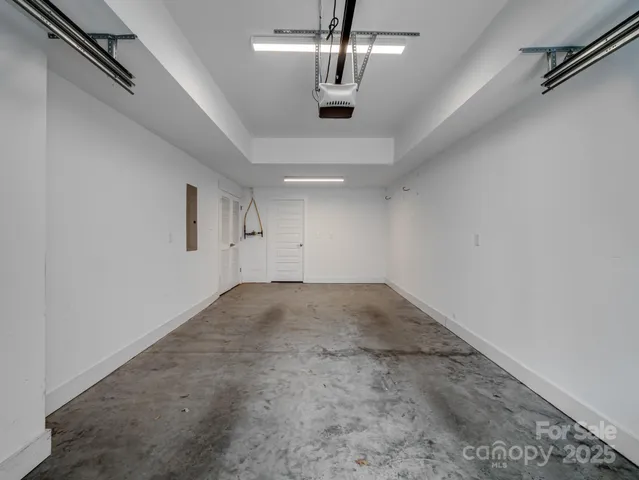 an empty room with chandelier fan