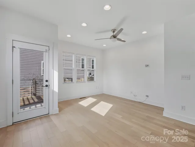 an empty room with windows and closet