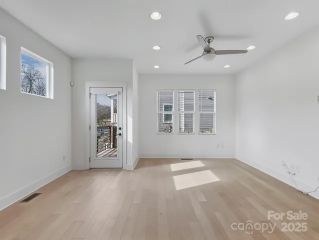 an empty room with windows and closet