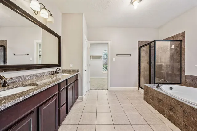 an empty room with windows and chandelier fan