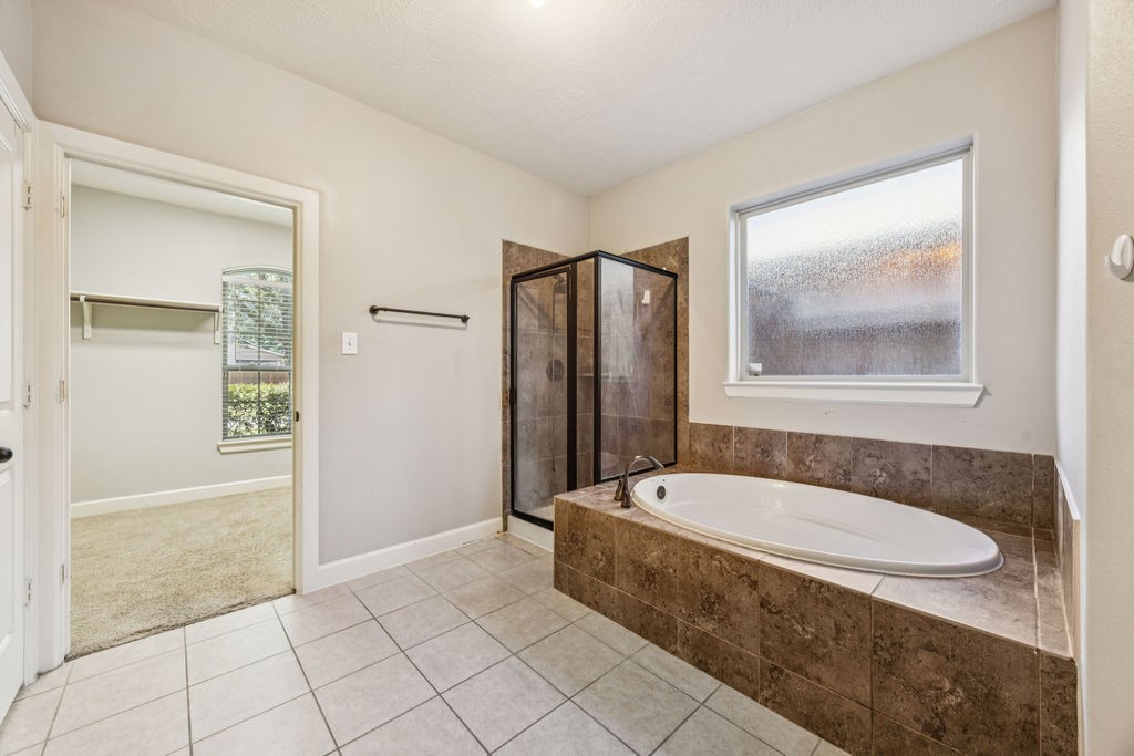 31306 Summit Grove Lane Spring, TX 77386 - Photo 12 of 45 a bathroom with a tub shower and mirror