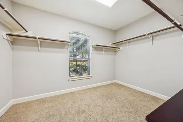 a bathroom with a granite countertop sink a toilet a mirror and shower