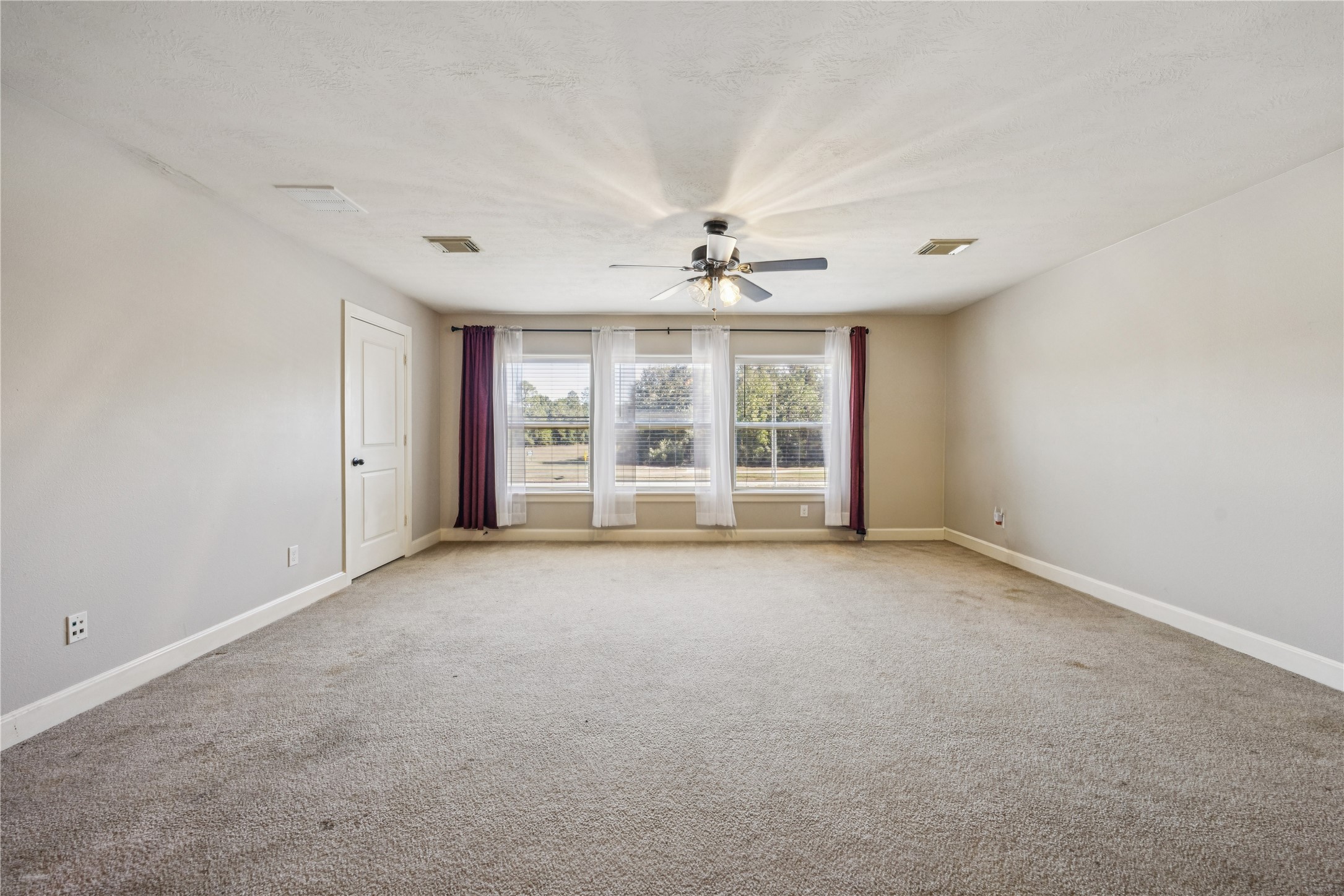 31306 Summit Grove Lane Spring, TX 77386 - Photo 15 of 45 an empty room with windows and chandelier fan