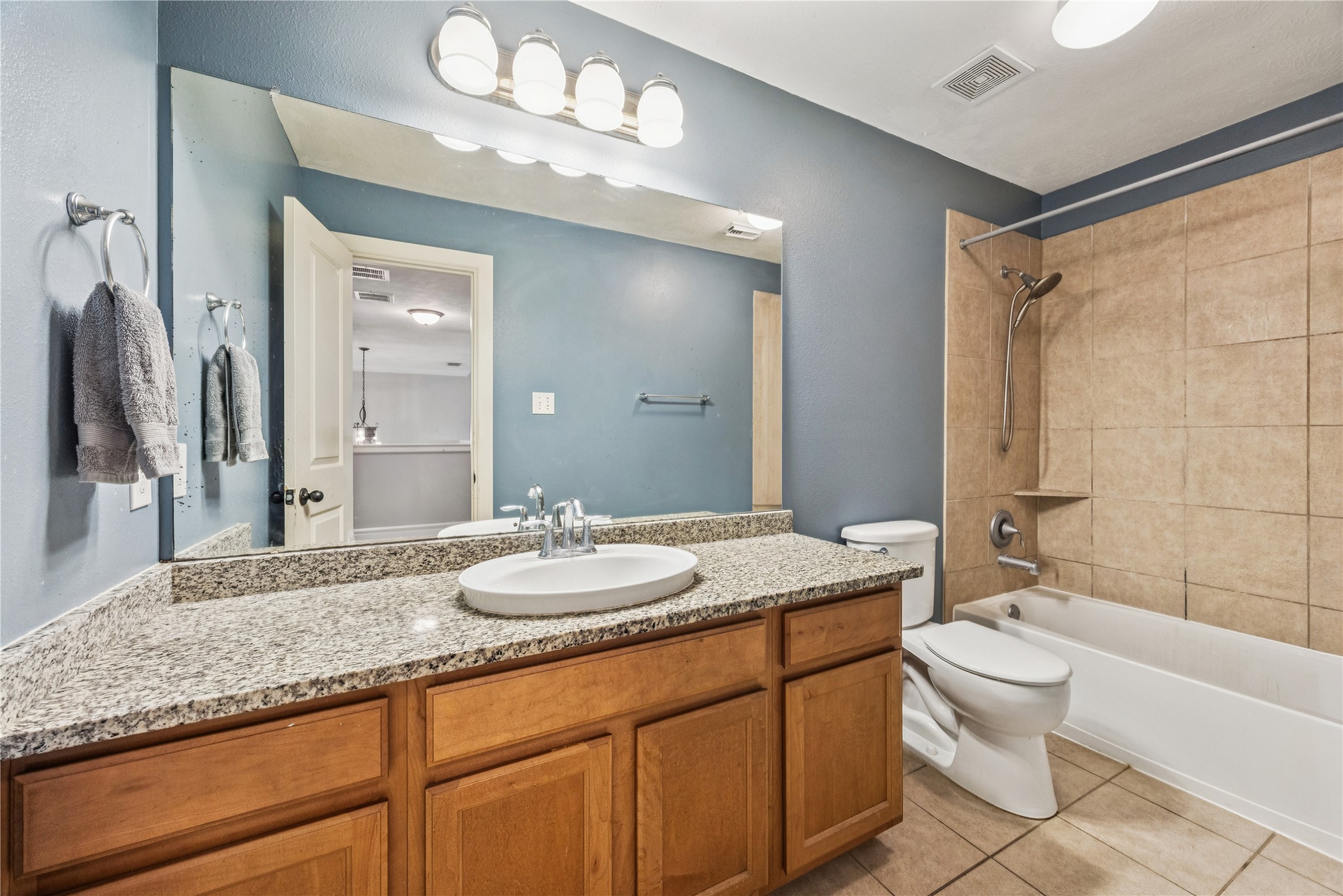 31306 Summit Grove Lane Spring, TX 77386 - Photo 17 of 45 a bathroom with a granite countertop sink a toilet a mirror and shower
