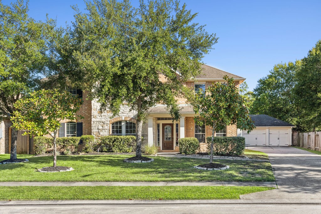 31306 Summit Grove Lane Spring, TX 77386 - Photo 26 of 45 a front view of a house with a garden