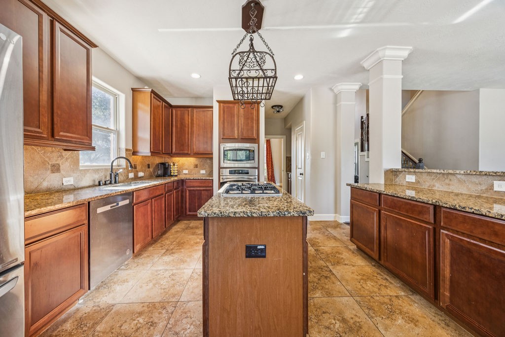 31306 Summit Grove Lane Spring, TX 77386 - Photo 4 of 45 a kitchen with stainless steel appliances granite countertop a sink stove and refrigerator