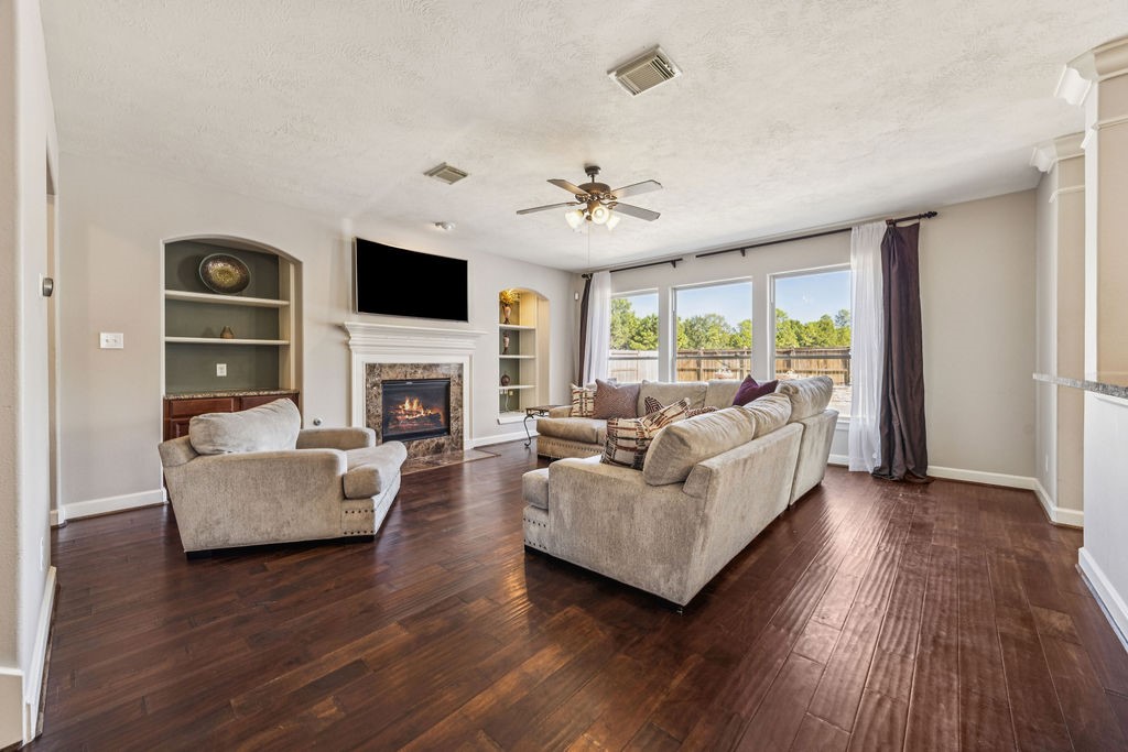 31306 Summit Grove Lane Spring, TX 77386 - Photo 5 of 45 a living room with furniture a flat screen tv and a fireplace