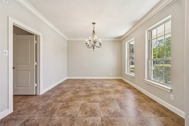 a spacious bedroom with a bed and a flat screen tv
