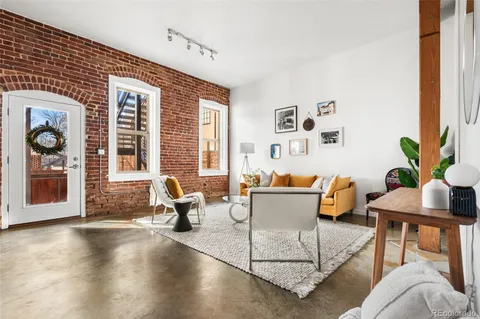 a living room with furniture and floor to ceiling windows