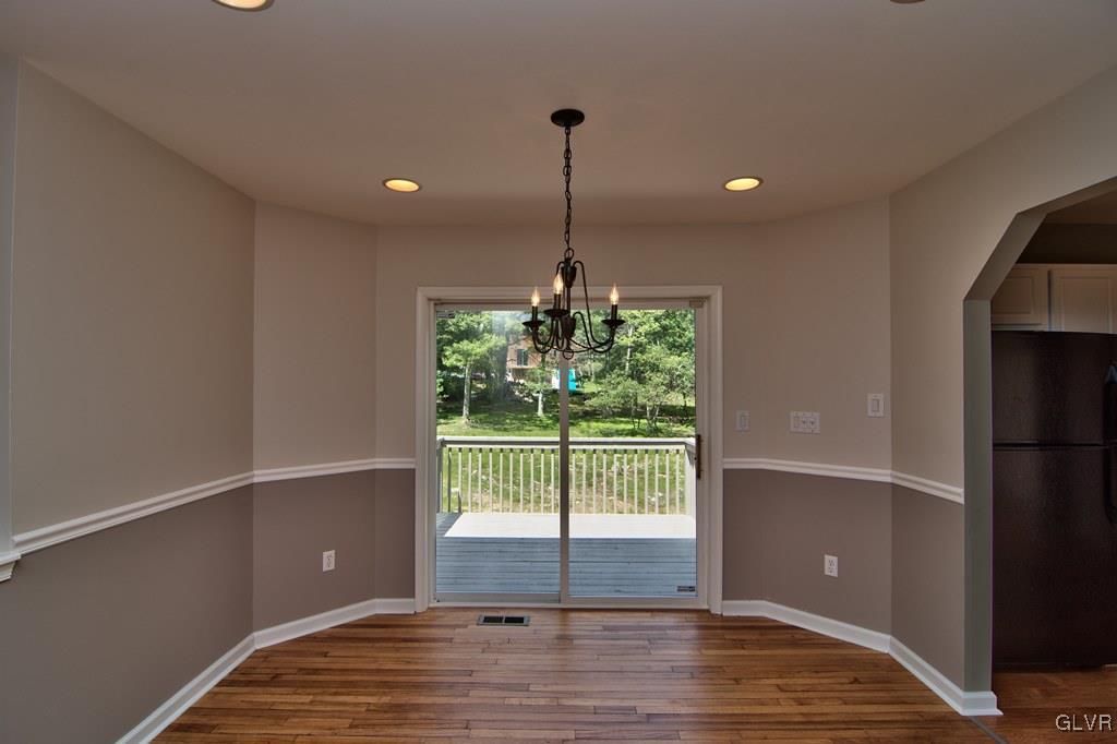 4913 Pine Ridge Drive West Bushkill, PA 18324 - Photo 11 of 50 The dining area features hardwood floors, decorati