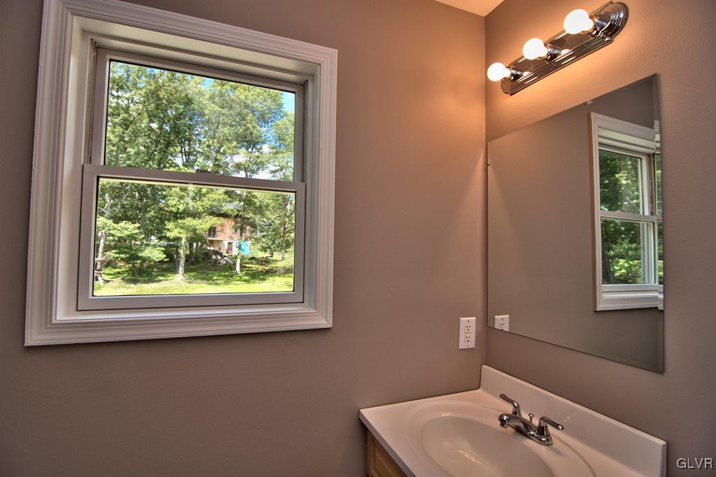 4913 Pine Ridge Drive West Bushkill, PA 18324 - Photo 24 of 50 View of the 1st floor half bath w/ lighted mirror
