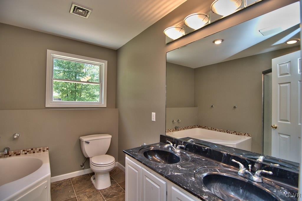 4913 Pine Ridge Drive West Bushkill, PA 18324 - Photo 31 of 50 View of the double sink w/ storage and lighted mir