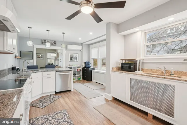 a kitchen with stove cabinets and chandelier