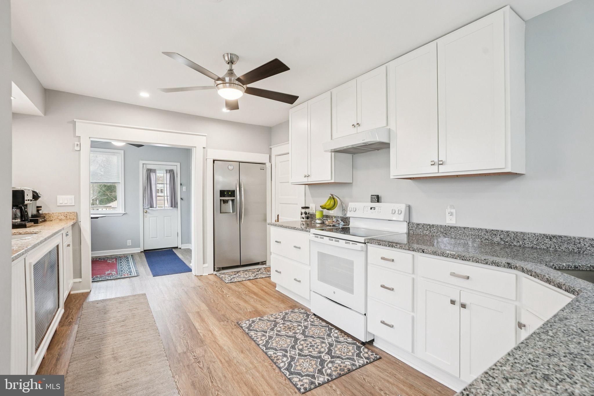 216-218 President Avenue Rutledge, PA 19070 - Photo 13 of 54 a large white kitchen with stainless steel appliances granite countertop lots of white cabinets a stove and dishwasher