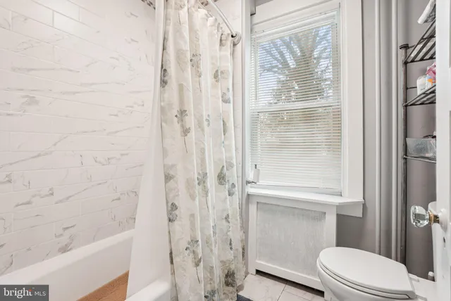 a view of a livingroom with furniture and a flat screen tv