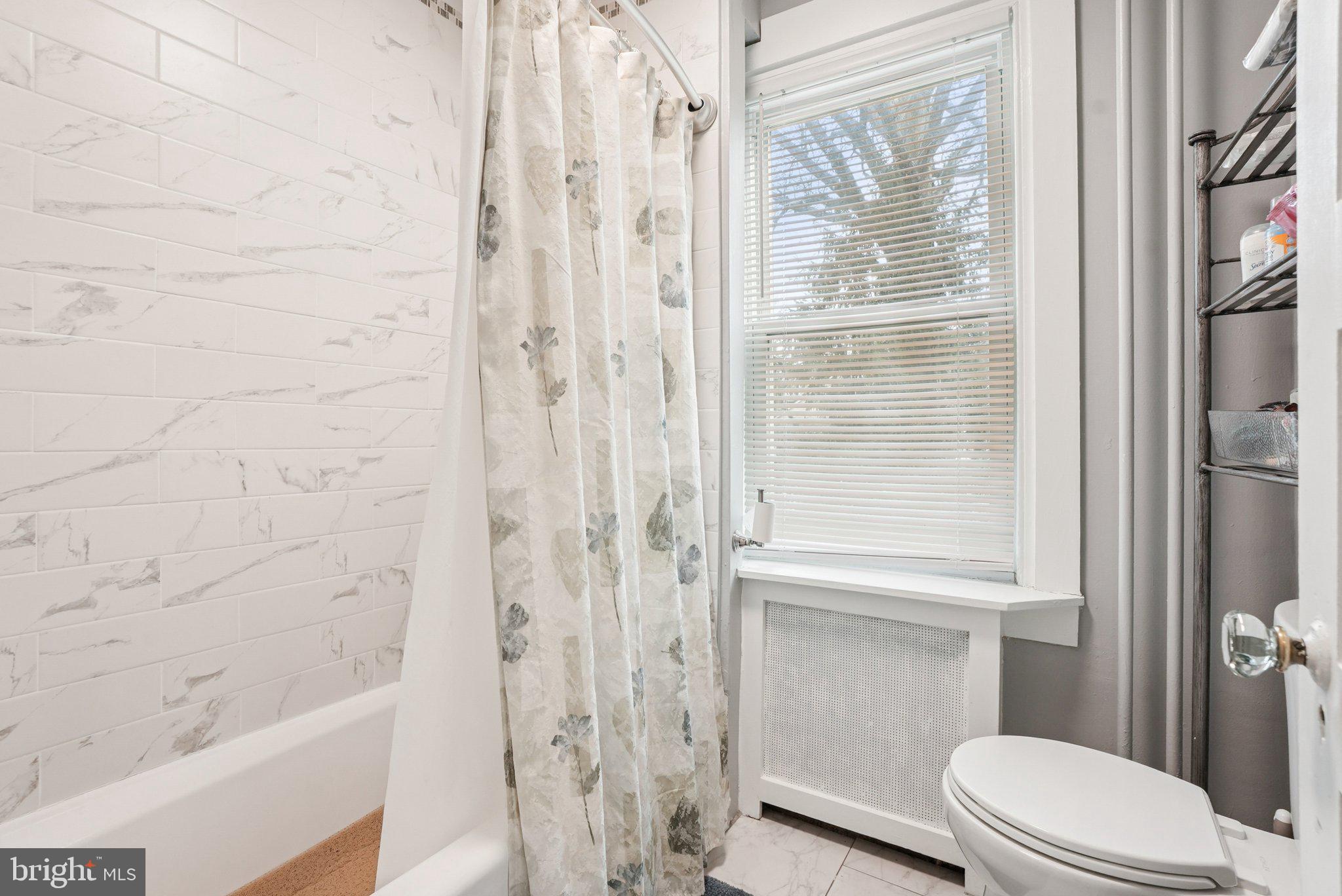 216-218 President Avenue Rutledge, PA 19070 - Photo 22 of 54 a bathroom with a shower a toilet and a window