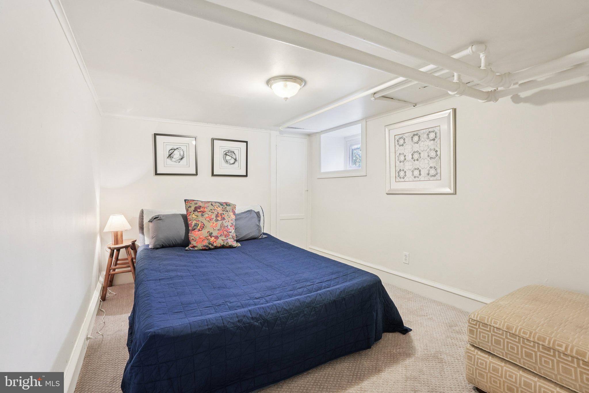 216-218 President Avenue Rutledge, PA 19070 - Photo 27 of 54 a large bedroom with a bed and paintings on the wall