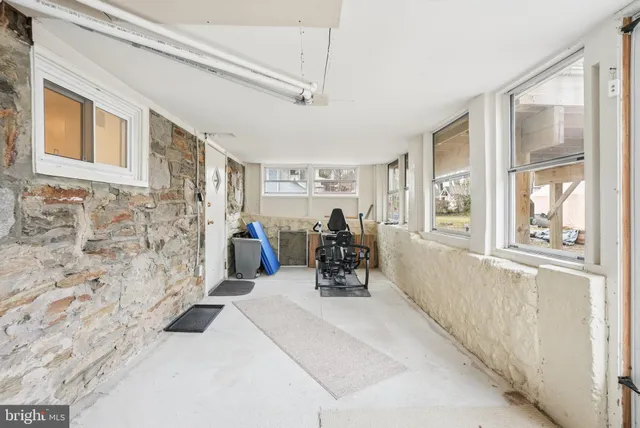 a living room with furniture a lamp and a window