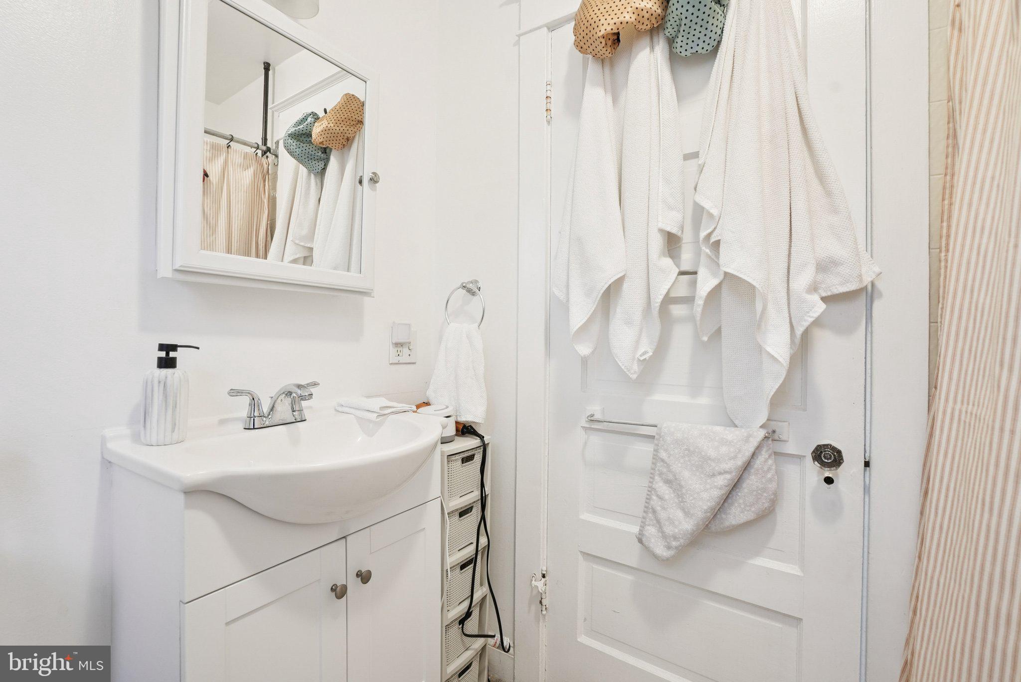 216-218 President Avenue Rutledge, PA 19070 - Photo 43 of 54 a bathroom with a sink vanity and a mirror
