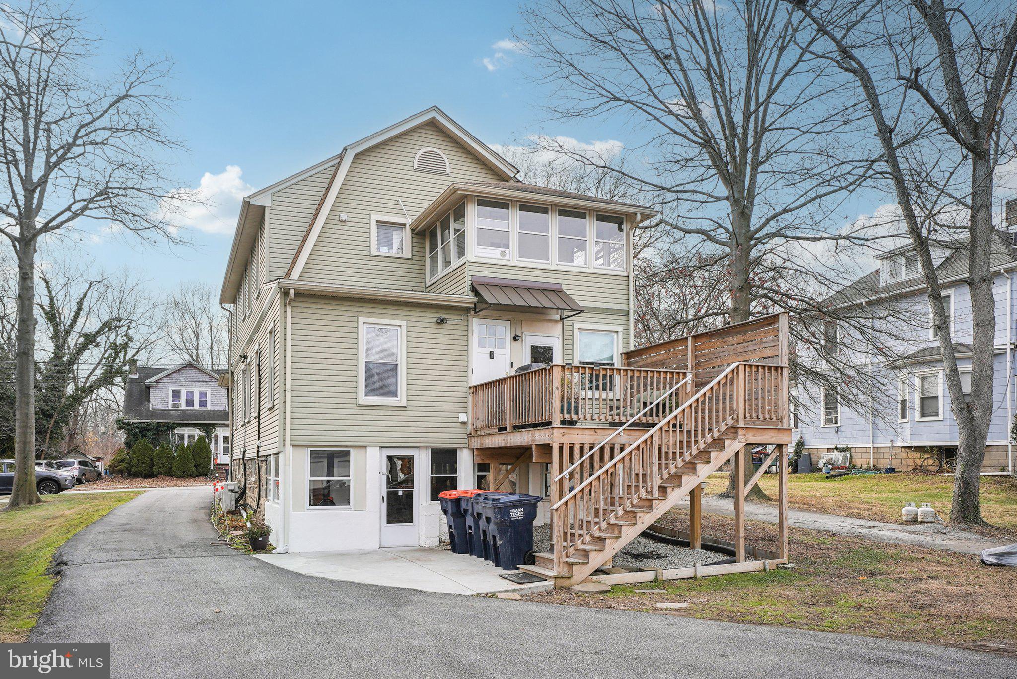 216-218 President Avenue Rutledge, PA 19070 - Photo 49 of 54 a view of a white house with large windows and a small yard