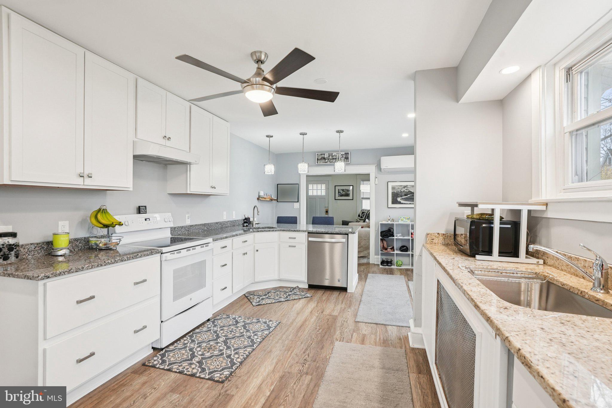 216-218 President Avenue Rutledge, PA 19070 - Photo 10 of 54 a kitchen with granite countertop a sink a counter top space stainless steel appliances and cabinets