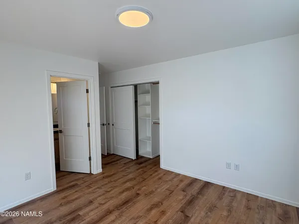 a view of an empty room and wooden floor