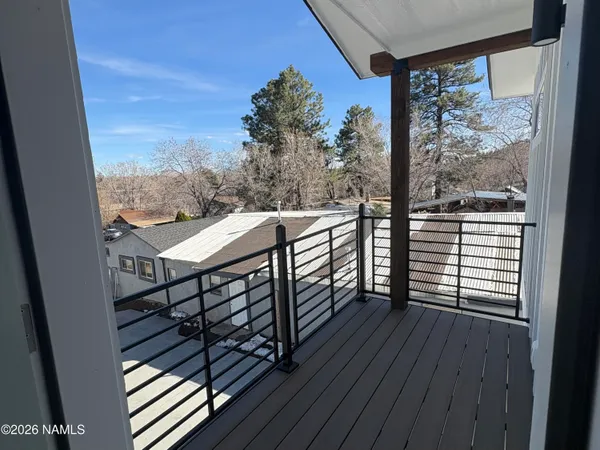 a view of a balcony with wooden floor