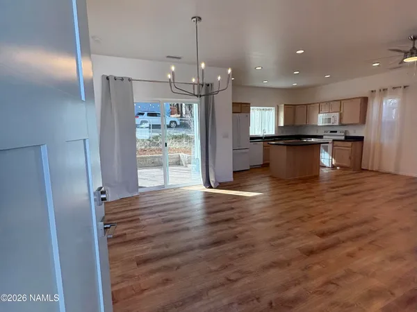 a view of kitchen with refrigerator microwave and stove