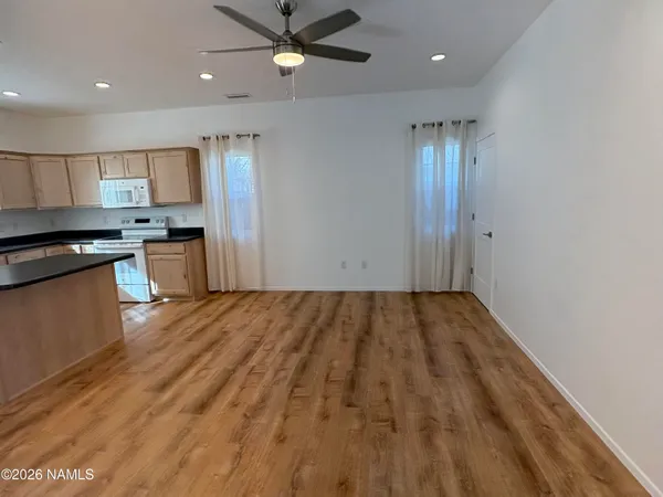 a view of a kitchen with a sink and stainless steel appliances