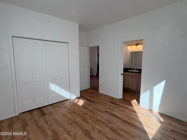 a view of kitchen with wooden floor and electronic appliances